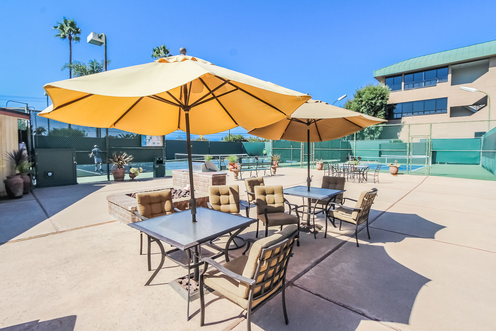 A lounging area next to the tennis courts at VRI's Winner Circle Resort in California.